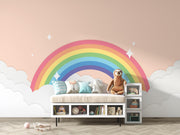 Children's room with a rainbow mural, clouds, and a meerkat plush toy.