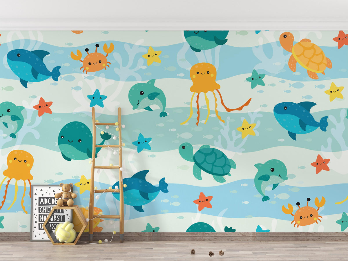 A children's room wall covered in a playful underwater mural with cartoon fish, octopus, turtle, whale, crab, starfish, and coral on a light blue and white wave pattern. A wooden ladder leans against the wall, with toys and a small sign on the floor below.