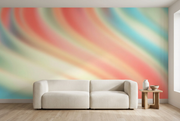 Pastel coral, mint and aqua abstract wall mural behind an ivory sofa in a living room mockup