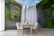 Skógafoss waterfall wall mural behind an oak dining table and cream chairs in a dining room mockup