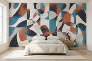 An abstract wall mural with flowing organic shapes in teal blue, terracotta orange, charcoal black, and white, shown behind a neatly made bed in a bright, modern bedroom.