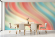 Pastel coral, mint and aqua abstract wall mural behind a light oak dining table and cream chairs in a dining room mockup
