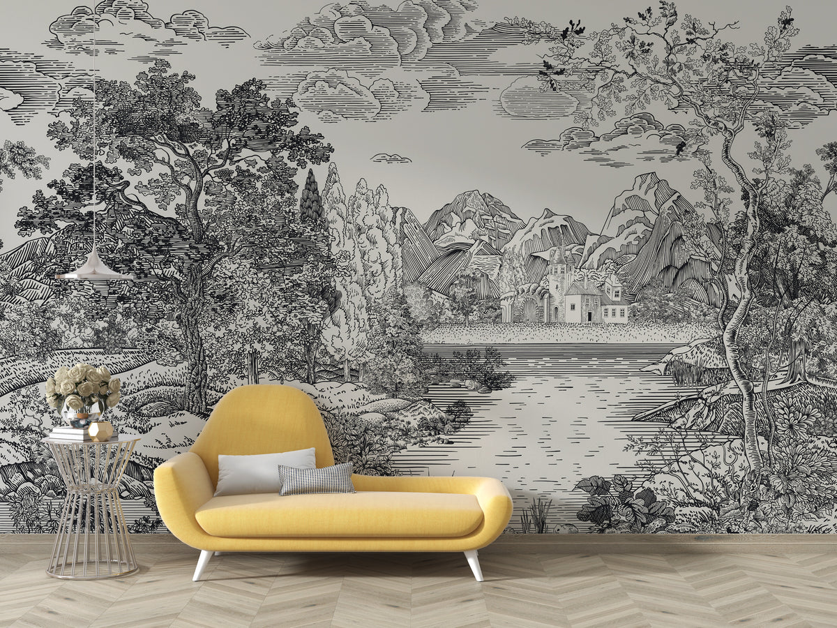 A large-scale black and white scenic wallpaper mural featuring a detailed landscape with mountains, trees, clouds, and a lake, styled in a room setting behind a modern yellow armchair.