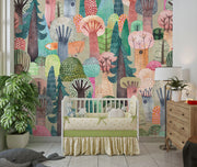 Children's room with colorful forest mural, crib, and decor elements.