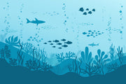 Underwater-themed wall mural featuring silhouettes of sharks, fish, and coral reefs in varying shades of blue, perfect for a calming and playful kids’ room.