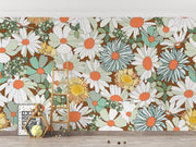 Wallpaper with colorful floral pattern on a wall with a ladder and decor items.