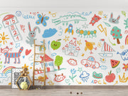 Colorful children's wall mural with various drawings on a white wall.