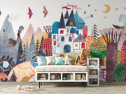 Colorful mural of a fantasy village with a sofa and shelves below.