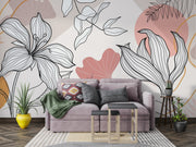 Living room with a floral wall mural, gray sofa, and decorative plants.