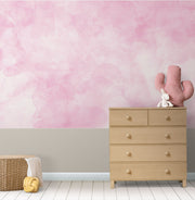 Blush Dreams soft pink watercolor wall mural in a kids nursery.