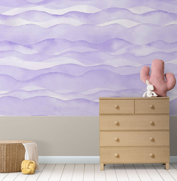 Purple wave-pattern wall mural with soft flowing designs, decorating a cosy children’s nursery.