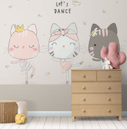 Adorable cat ballerina mural in soft pastel colors, showing three dancing cats in tutus with the phrase "Let's Dance" above them, decorating a nursery.