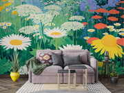 Gray sofa with decorative pillows in a room with a vibrant floral wall mural.