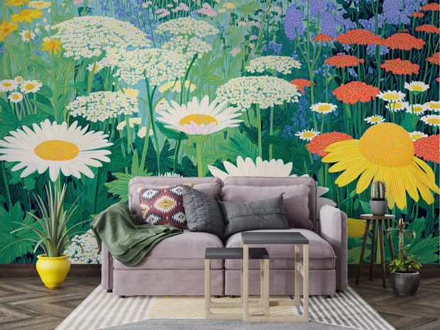 Gray sofa with decorative pillows in a room with a vibrant floral wall mural.
