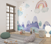 Watercolor kids' room mural with pastel mountains, a rainbow, a sun, clouds, and stars for a dreamy, playful atmosphere.