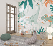 Kids’ bedroom wall mural featuring cute dinosaurs like triceratops, sauropod, and pterodactyls in a soft leafy landscape design.