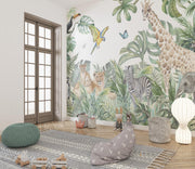 Safari adventure wall mural featuring watercolor jungle animals such as lions, giraffes, zebras, and parrots, styled in a cozy kids' playroom.