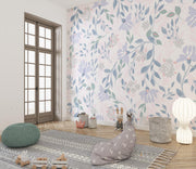 Delicate pastel floral wall mural with soft lavender, blush pink, and green botanical patterns in a kids' playroom.