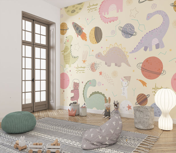 Children's playroom with Dino Galaxy Wall Mural featuring whimsical dinosaurs, rockets, planets, and stars in pastel colors, creating a magical space-themed decor.