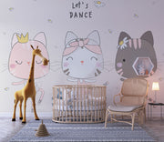 Adorable cat ballerina mural in soft pastel colors, showing three dancing cats in tutus with the phrase "Let's Dance" above them, decorating a children’s nursery.