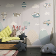 Aviation-themed wall mural for kids featuring airplanes, helicopters, hot air balloons, and mountains in soft pastel colors, perfect for a nursery or playroom.