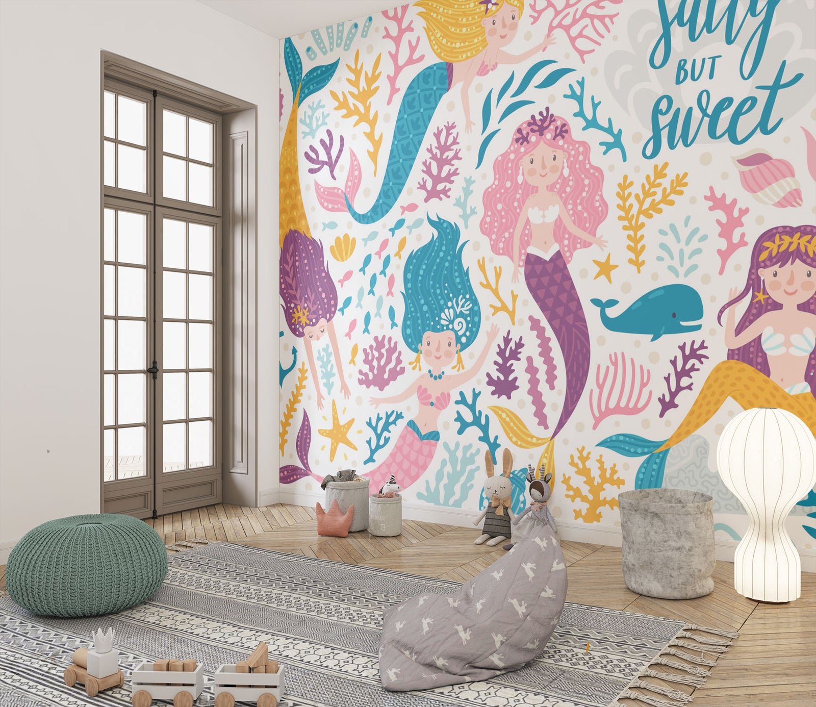 Colorful mermaid-themed wall mural in a children's playroom, featuring smiling cartoon mermaids with vibrant tails, sea creatures and coral.