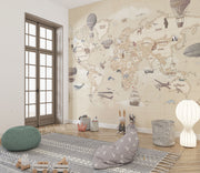Vintage-style children's world map wall mural with hot air balloons and animals, styled in a kid's playroom.