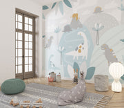 Pastel dinosaur wall mural with friendly dinosaurs, volcano, and soft greenery in muted colors, ideal for decorating nurseries, playrooms, and kids’ bedrooms.