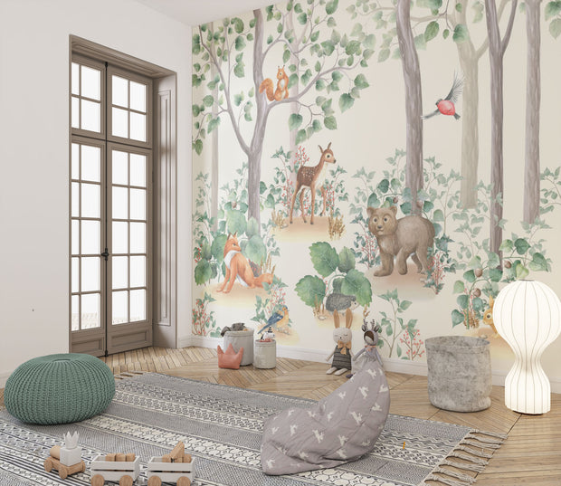 Woodland-themed wall mural featuring a bear cub, deer, squirrel, birds and lush green trees, decorating a cozy children's bedroom with a wooden house bed and natural decor.
