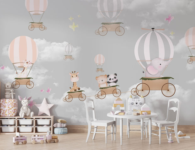 Whimsical hot air balloon animal wall mural featuring giraffes, pandas, elephants, and bears floating in the sky with soft pastel clouds – perfect for kid's rooms and nurseries.